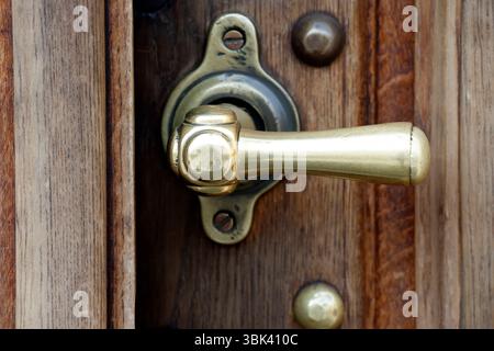 Carved wooden church door with a brass handle.. Warsaw. Poland. Stock Photo