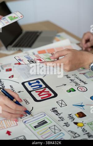 Collaborative UX UI Design Session. Team members sharing design ideas. Stock Photo