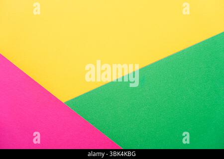 Triangular composition of pink, yellow, and green paper. Stock Photo