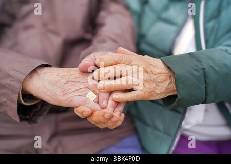 Elderly Couple Holding Hands with Arthritis Stock Photo