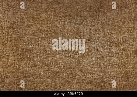 Rustic paving pattern with earthy brown tones. Natural stone mosaic evokes southern European warmth, tradition, and vintage ambiance. Stock Photo