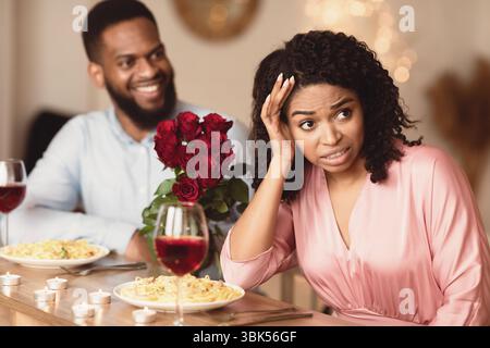 Black Woman On Unsuccessful First Date In Restaurant Stock Photo