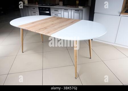 Transformer table. Extendable dining table set. Wood kitchen and dining room furniture, space saving console table Stock Photo