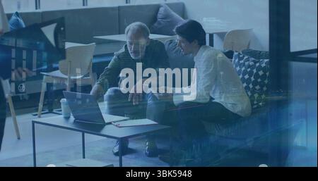 Pointing and checking smartphone two colleagues working in office lounge, with laptop, clapperboard Stock Photo