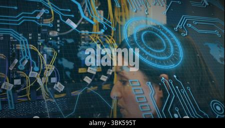 Examining female IT tech inspecting network rack in server room, with ethernet cables, copy space Stock Photo