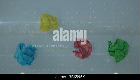 Displaying four paper balls in yellow blue red green on digital code overlay, with security alerts Stock Photo