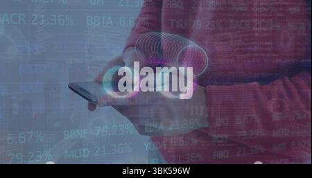 Man wearing red sweater holding smartphone at chest in grey studio, with AR rings and codes Stock Photo