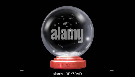Displaying decorative snow globe with white snowflakes in glass sphere at studio, red star base Stock Photo