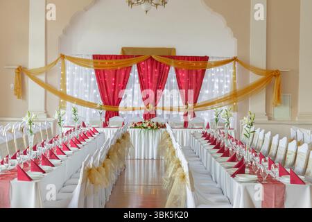 Large dining hall with tables set up white tablecloth Stock Photo