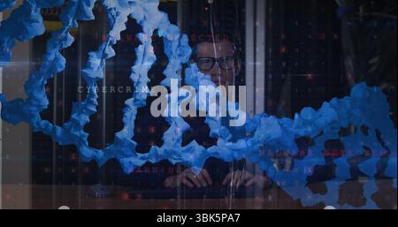 Analyzing man in dark sweater examining malware warning code at control room desk, blue chain links Stock Photo