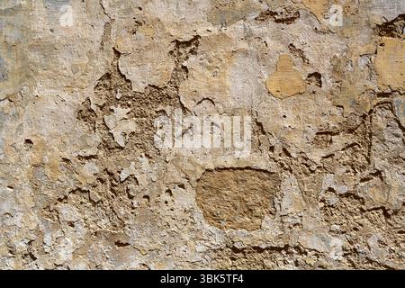 Old wall with peeling plaster or stucco for use as a background texture Stock Photo