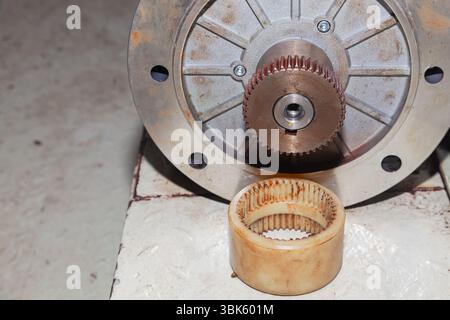 A removed electric motor with a gear on its shaft. Stock Photo
