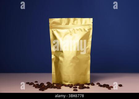 One zipper stand-up pouch with coffee beans on pink table against blue background. Mockup for design Stock Photo
