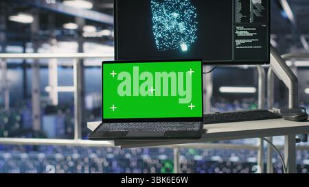 Industrial platform workstation in automated data center displaying deep learning code on isolated screen laptop. Server room mockup notebook running AI models monitoring operational stability Stock Photo