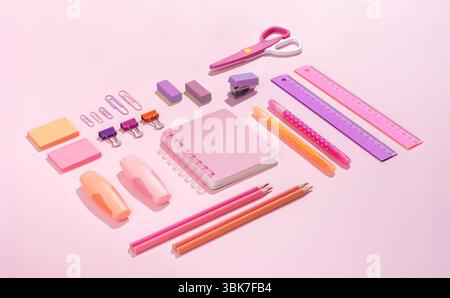 Assorted Pink and Purple School and Office Stationery on a pink Pastel Background Stock Photo