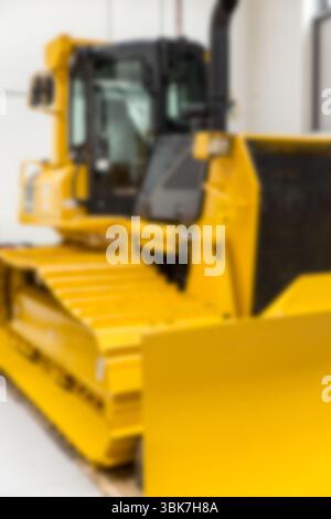 Yellow bulldozer is sitting inside flat design warehouse, showing cabin controls and front blade Stock Photo