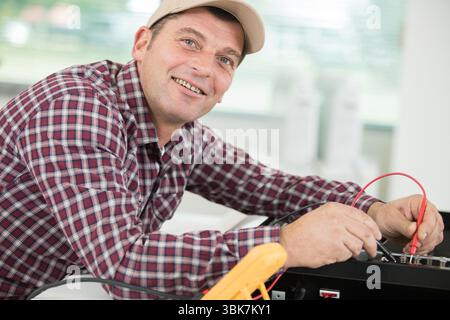 portrait of worker using multimeter Stock Photo