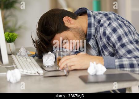 drunk businessman sleeping in office Stock Photo