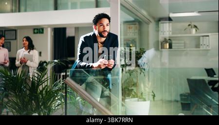 Phone, thinking and business man in office for idea, decision or vision for sustainable project. Mobile, serious worker and reflection in lobby for Stock Photo