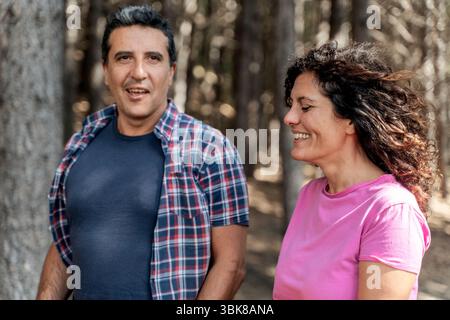 A beautiful mature couple smiling and talking together. A husband and wife enjoying a happy, healthy, and active lifestyle outdoors Stock Photo