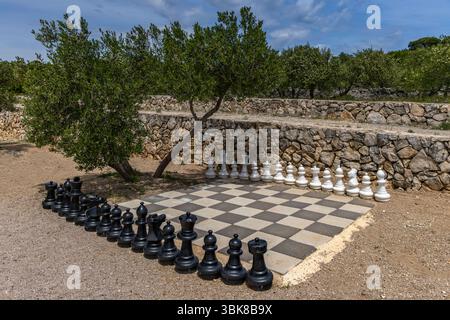 A chessboard with pawns and chess pieces on the beach in Punat, KRK Stock Photo