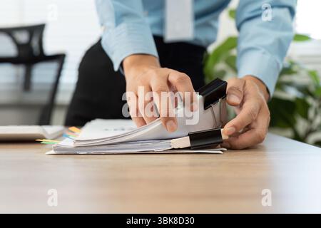 Document Organization and Management. Professional organizing paperwork with binder clips. Stock Photo