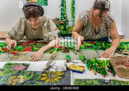 Weavers Margot and Aurelie trained at the Cité internationale de la tapisserie in Aubusson. One of the institution's goals is to pass on the centuries-old knowledge of Aubusson tapestry as cultural heritage. It is designed as a centre of excellence that supports craftsmanship, artistic innovation and education and training in equal measure. Rue Williams Dumazet, Aubusson, Nouvelle-Aquitaine, France Stock Photo