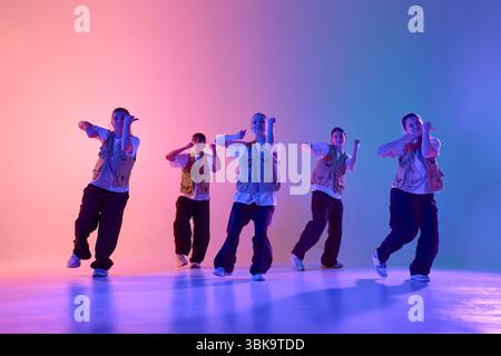 Youthful energy vibrant urban dance crew performing creative expressive choreography Stock Photo