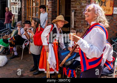 A group of Morris Dancers relaxing outside The Gardeners Arms Pub during the annual ’Sussex Day of Dance’ event, Lewes, Sussex, UK. Stock Photo