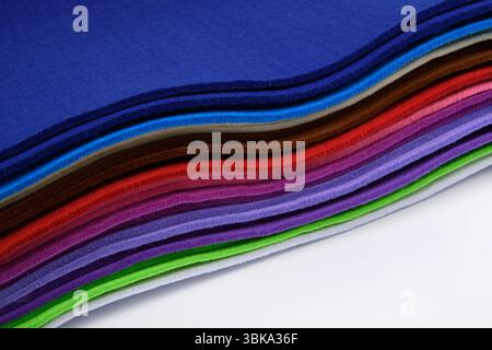 Colorful multi-colored felt on a white background. Soft fabric samples. Wave. Close-up. For design projects textile mockups sewing and craft materials Stock Photo