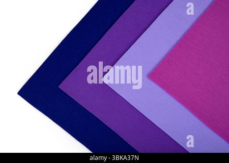 Colorful thick fabric sheets in purple and pink tones on a white background in a triangular shape. Stock Photo
