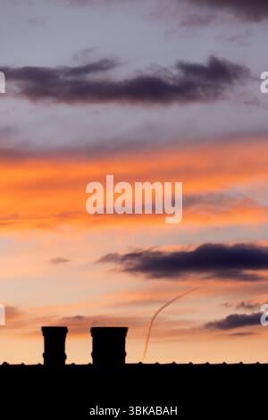 Dramatic sky with orange and dark clouds after storm Stock Photo