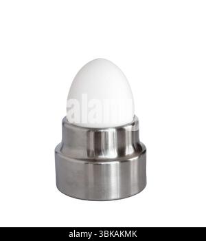 White whole breakfast egg in stainless steel egg holder isolated cutout Stock Photo