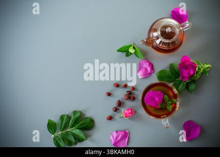 Top view of brewed rosehip tea with mint in glassware. Stock Photo