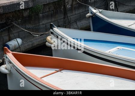 Three motorboats moored in the harbour at Bardolino, Lake Garda, Northern Italy Stock Photo