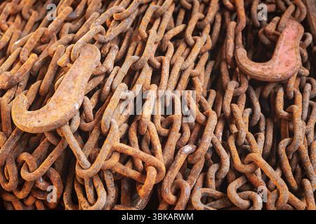 Old rusty chains with hooks for fastening a heavy load close-up. Stock Photo
