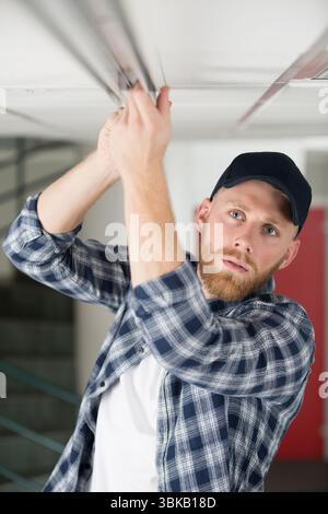 young guy repairs ceiling Stock Photo
