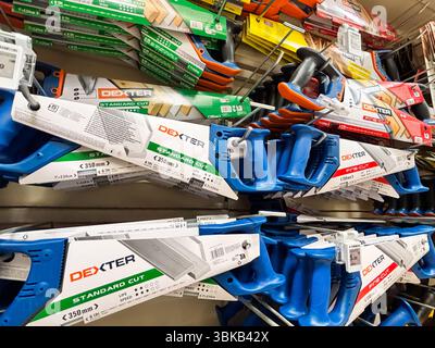 Alicante, Spain - June 18, 2025: Dexter hand saws displayed on a retail shelf, showcasing various sizes and colors, ideal for woodworking and DIY Stock Photo