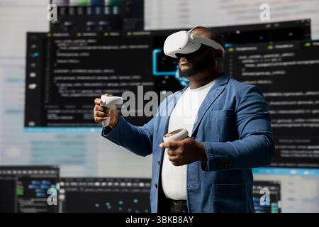 Black IT specialist engineer using VR headset and coding at innovation hub, showcasing the intersection of data science and cloud computing. Coding life with modern AI tools. Stock Photo