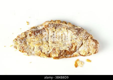 One almond croissant with crumbs on a white background Stock Photo