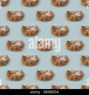 Puff pastry buns of fancy shape, with crumbs, on a blue background, pattern Stock Photo