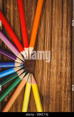 Color pencils arranged on wooden table Stock Photo