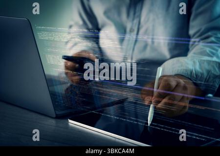 A programming code on representing person working laptop with digital code and tablet, using stylus, modern workspace, focused technology Stock Photo