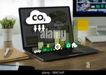 A business sustainability image shows laptop desk displaying environmental and sustainability icons related to carbon dioxide reduction Stock Photo