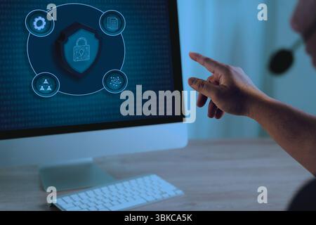 A data protection privacy person using computer with cybersecurity and data protection interface screen, emphasizing digital security and privacy Stock Photo