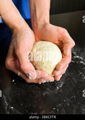 Female baker kneading dough. Handmade bread cooking. Culinary expertise. Kitchen, food preparation, recipe preparation. Stock Photo