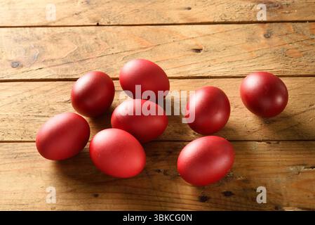 Traditional Greek Easter red dyed eggs in basket on wooden table Orthodox Easter symbol Stock Photo