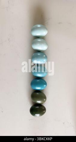 Gradient of blue colored eggs arranged vertically Stock Photo