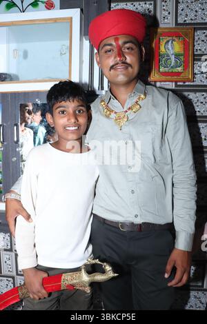 Indian groom with younger brother standing together in traditional attire Stock Photo