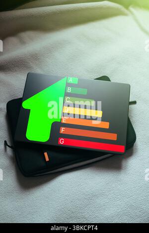 Energy efficiency concept. Laptop top view with energy efficiency rating for energy efficient house. Future is green. Stock Photo